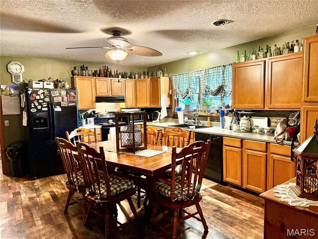 42 Berger Rd, Middletown, MO 63359 - kitchen featuring black appliances, a sink, under cabinet range hood, light wood finished floors, and a textured ceiling