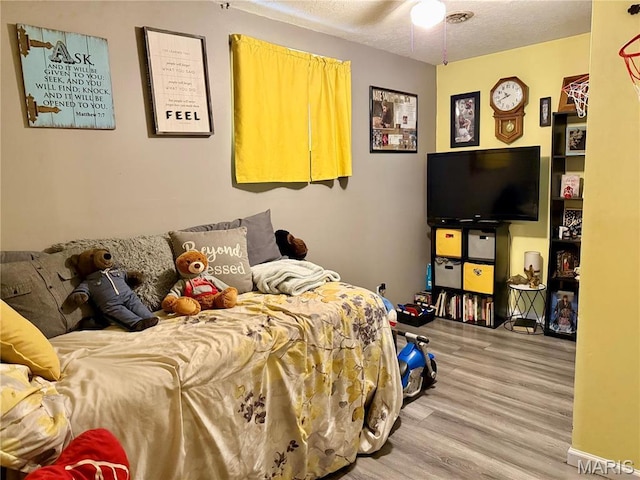 42 Berger Rd, Middletown, MO 63359 - bedroom featuring wood finished floors and a textured ceiling