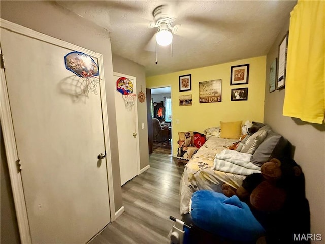42 Berger Rd, Middletown, MO 63359 - bedroom featuring wood finished floors, a ceiling fan, and baseboards