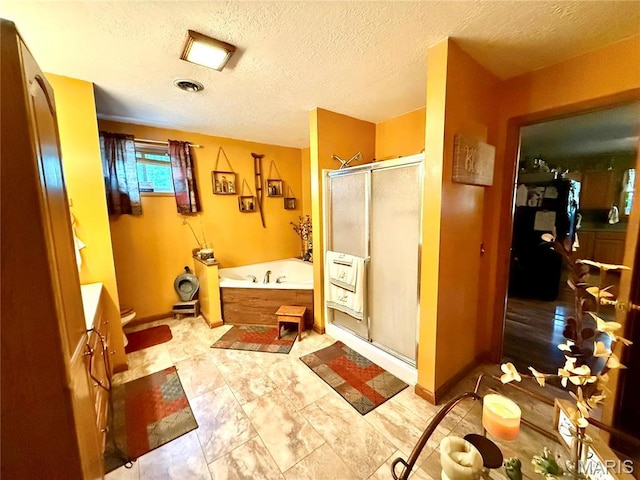 42 Berger Rd, Middletown, MO 63359 - bathroom with a shower stall, a garden tub, a textured ceiling, heating unit, and toilet
