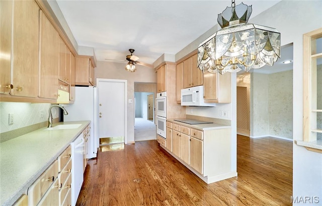 10359 Corbeil Dr Unit D, Saint Louis, MO 63146 - kitchen with light brown cabinetry, a sink, wood finished floors, and a chandelier