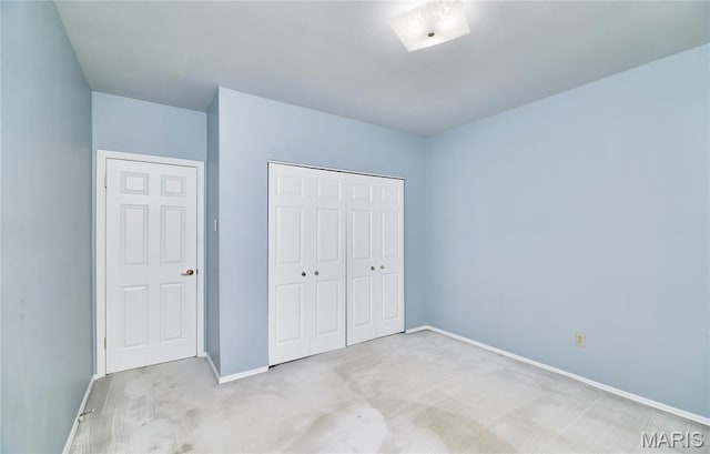 10359 Corbeil Dr Unit D, Saint Louis, MO 63146 - unfurnished bedroom featuring light carpet, baseboards, and a closet