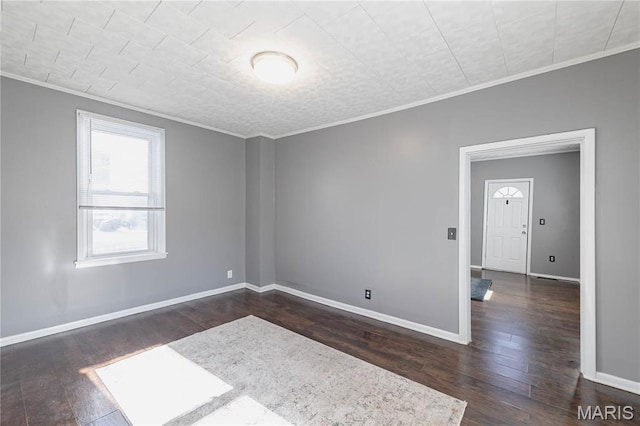 7122 Drury Ln, Saint Louis, MO 63143 - spare room featuring ornamental molding, dark wood-style flooring, and baseboards