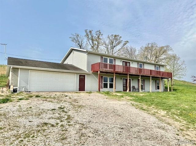 view of front of house with a garage, driveway, and a deck