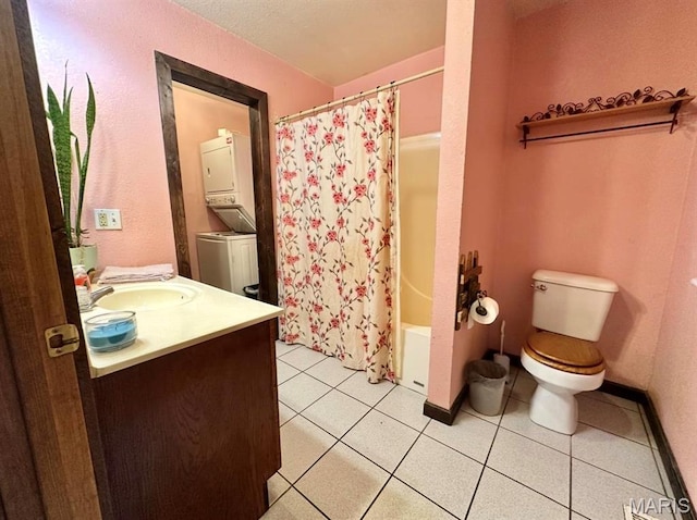 full bathroom featuring stacked washer / dryer, toilet, tile patterned flooring, vanity, and shower / bath combo with shower curtain