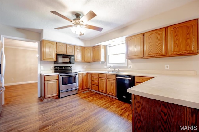 6 Mapleleaf Ln, Belleville, IL 62223 - kitchen with electric range, black microwave, dishwasher, a sink, and a ceiling fan