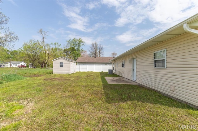 1501 Vincent St, Poplar Bluff, MO 63901 - view of green lawn featuring central AC unit, an outbuilding, and a storage unit