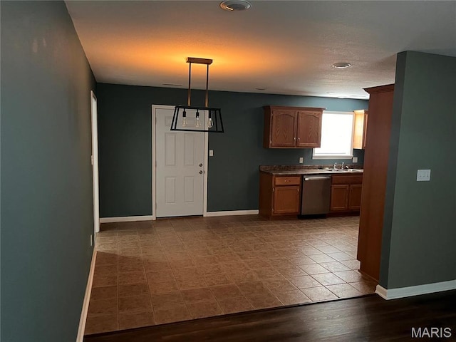 1501 Vincent St, Poplar Bluff, MO 63901 - kitchen with dishwasher, a sink, baseboards, and dark countertops