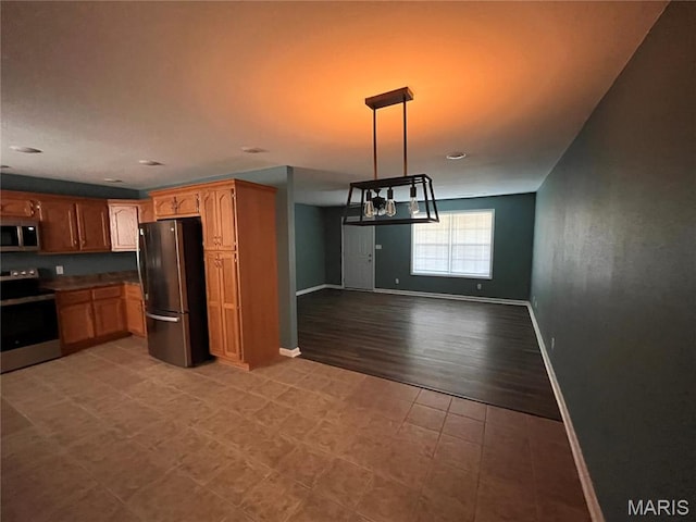 1501 Vincent St, Poplar Bluff, MO 63901 - kitchen with appliances with stainless steel finishes, baseboards, open floor plan, decorative light fixtures, and a chandelier