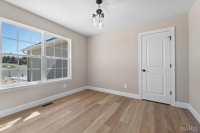 1423 Wild Ridge Estates Ct, Florissant, MO 63033 - empty room featuring light wood-type flooring and baseboards