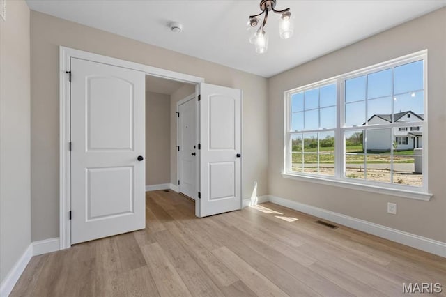 1423 Wild Ridge Estates Ct, Florissant, MO 63033 - unfurnished room with baseboards and light wood-style floors