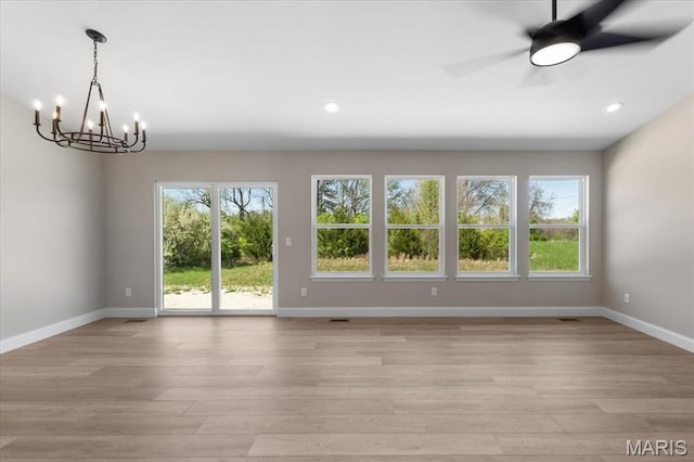 1423 Wild Ridge Estates Ct, Florissant, MO 63033 - unfurnished dining area featuring light wood-type flooring, a chandelier, baseboards, ceiling fan, and recessed lighting