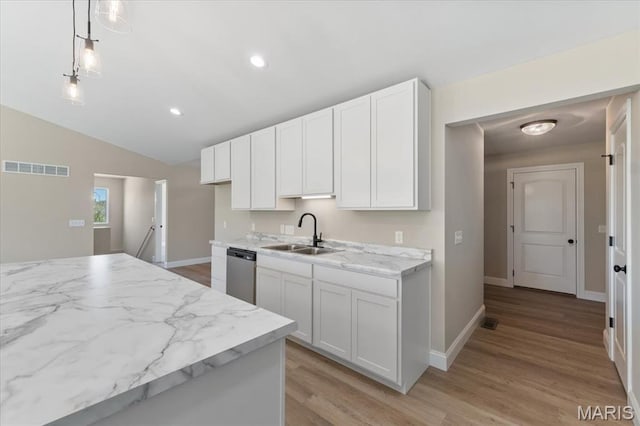 1423 Wild Ridge Estates Ct, Florissant, MO 63033 - kitchen with stainless steel dishwasher, a sink, light wood-type flooring, white cabinets, and vaulted ceiling