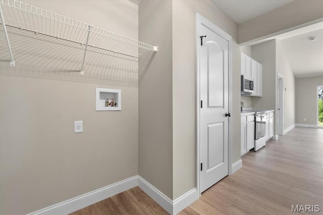 1423 Wild Ridge Estates Ct, Florissant, MO 63033 - washroom with hookup for a washing machine, baseboards, light wood-type flooring, and electric dryer hookup