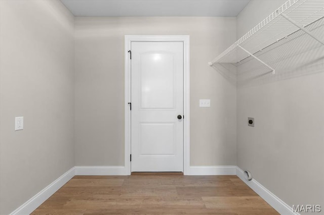 1423 Wild Ridge Estates Ct, Florissant, MO 63033 - washroom with electric dryer hookup, light wood finished floors, and baseboards