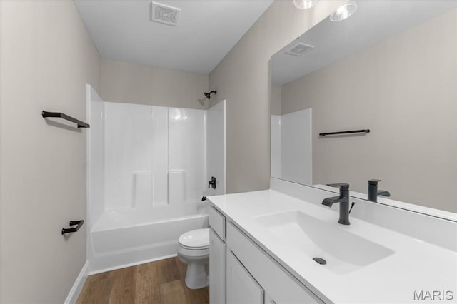 1423 Wild Ridge Estates Ct, Florissant, MO 63033 - full bath featuring toilet, wood finished floors, vanity, shower / tub combination, and baseboards
