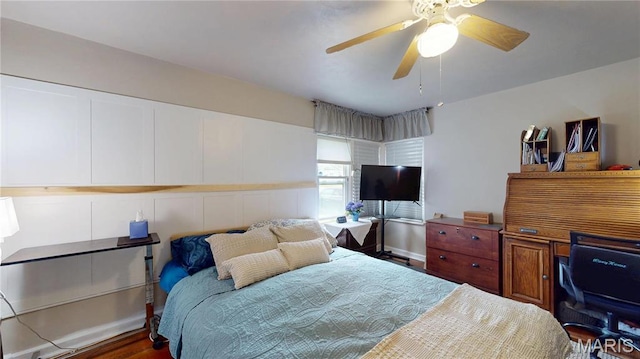 bedroom featuring a desk, wood finished floors, and a ceiling fan