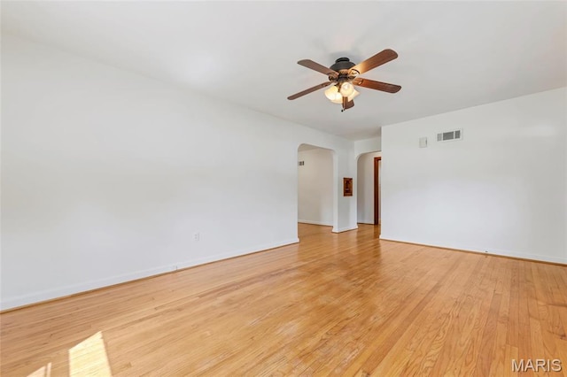 509 N Jefferson St, Mascoutah, IL 62258 - spare room with arched walkways, a ceiling fan, light wood-style flooring, and baseboards
