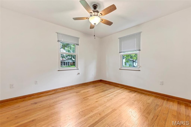 509 N Jefferson St, Mascoutah, IL 62258 - unfurnished room with plenty of natural light, light wood-style floors, baseboards, and a ceiling fan