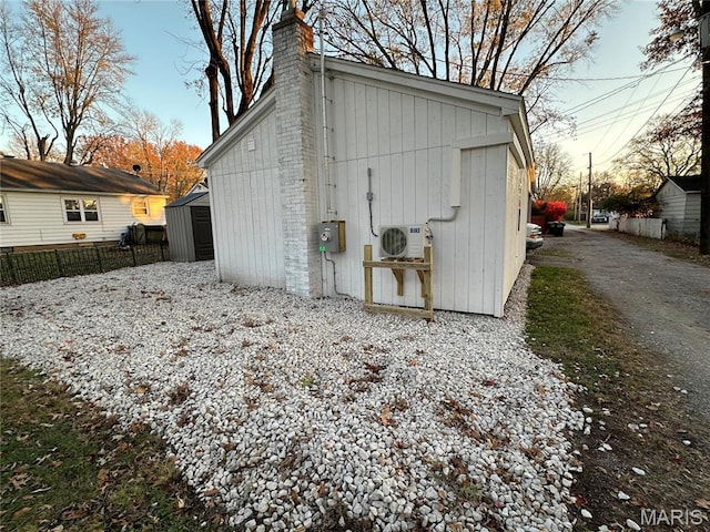 509 N Jefferson St, Mascoutah, IL 62258 - view of shed featuring gravel driveway, a cooling unit, and fence