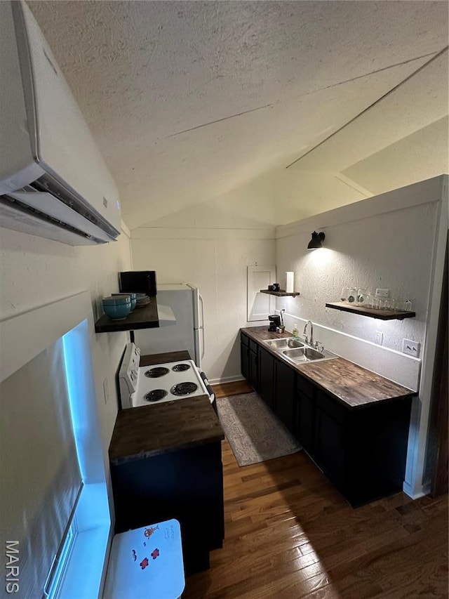 509 N Jefferson St, Mascoutah, IL 62258 - kitchen featuring a sink, dark wood-style flooring, vaulted ceiling, white appliances, and a textured ceiling