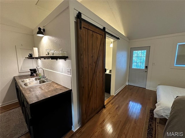 509 N Jefferson St, Mascoutah, IL 62258 - kitchen with vaulted ceiling, a sink, open shelves, hardwood / wood-style flooring, and a barn door