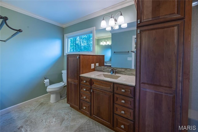 bathroom with toilet, ornamental molding, baseboards, vanity, and tasteful backsplash