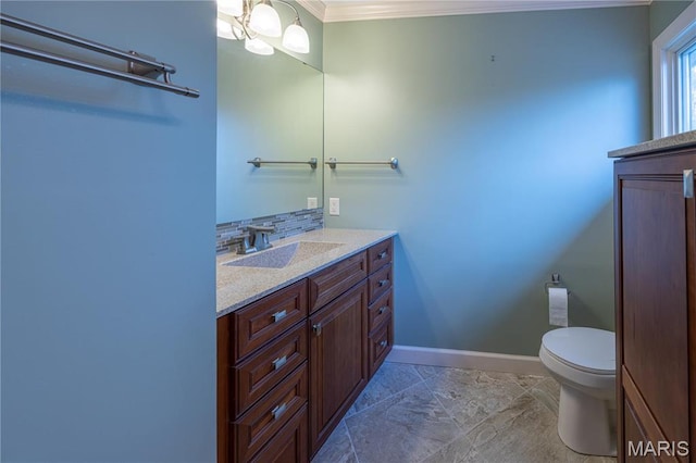 half bath featuring ornamental molding, vanity, toilet, baseboards, and backsplash