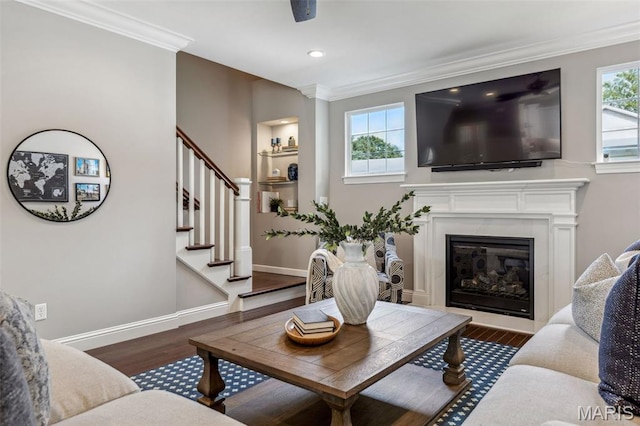 11910 Lillian Ave, Saint Louis, MO 63131 - living room featuring ornamental molding, wood finished floors, stairway, a fireplace, and baseboards