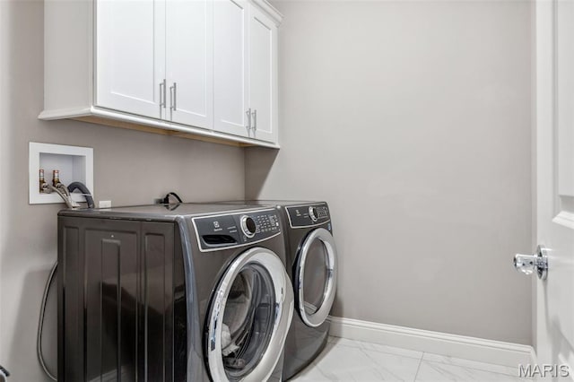 11910 Lillian Ave, Saint Louis, MO 63131 - clothes washing area with cabinet space, marble look tiles, washer and clothes dryer, and baseboards