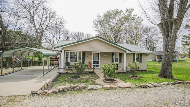 14153 Spring Dr, De Soto, MO 63020 - view of front of property featuring a porch, a detached carport, driveway, and metal roof