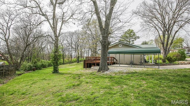 14153 Spring Dr, De Soto, MO 63020 - view of grassy yard featuring a carport, a wooden deck, and driveway