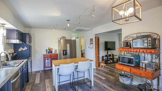 14153 Spring Dr, De Soto, MO 63020 - kitchen featuring appliances with stainless steel finishes, a sink, dark wood finished floors, wooden counters, and blue cabinetry