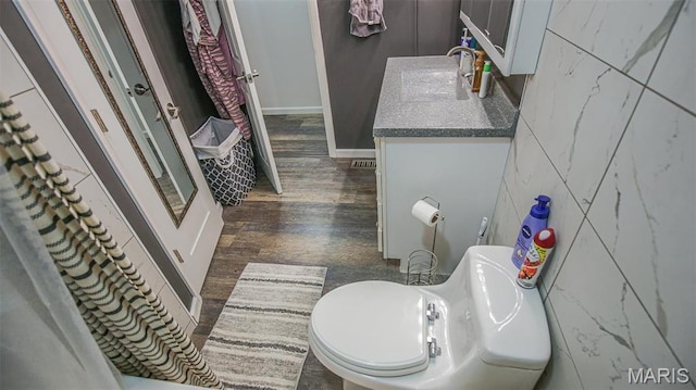 14153 Spring Dr, De Soto, MO 63020 - bathroom featuring wood finished floors, toilet, vanity, and tile walls