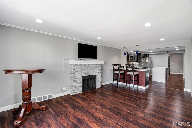831 Diversey Dr, Saint Louis, MO 63126 - living room with baseboards, dark wood finished floors, recessed lighting, a fireplace, and crown molding