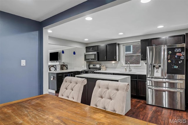 831 Diversey Dr, Saint Louis, MO 63126 - kitchen featuring stainless steel appliances, a sink, light countertops, dark wood-type flooring, and recessed lighting