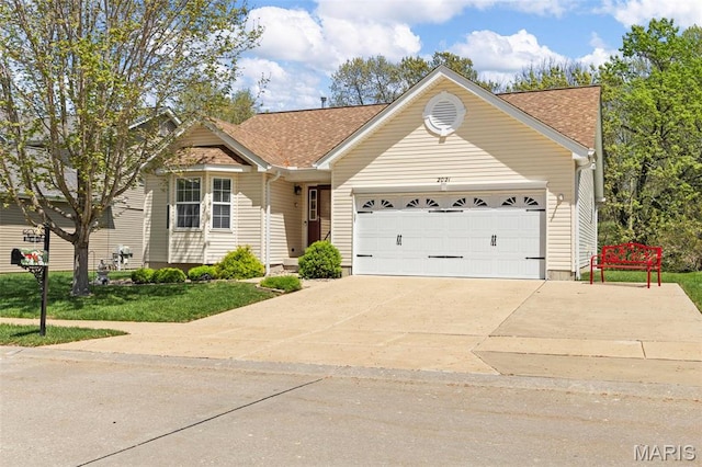 view of front of home with driveway, an attached garage, a shingled roof, and a front lawn
