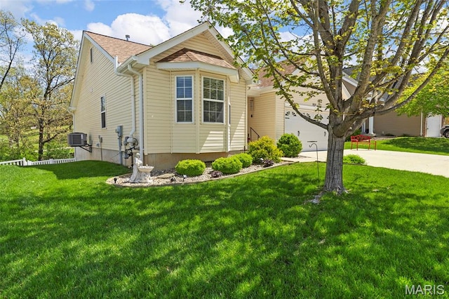 view of front of house featuring concrete driveway, a front yard, and cooling unit