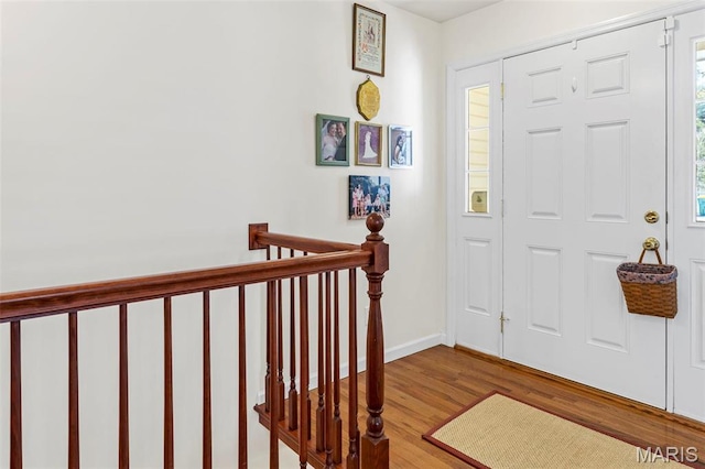 foyer featuring wood finished floors and baseboards