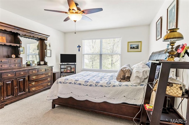 bedroom with light carpet and ceiling fan