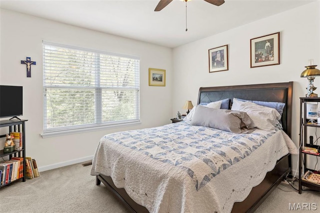 bedroom featuring multiple windows, carpet floors, baseboards, and ceiling fan
