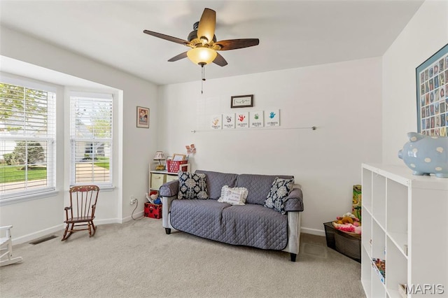 carpeted bedroom with multiple windows, baseboards, and a ceiling fan