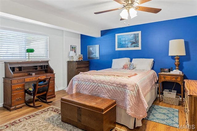 bedroom featuring wood finished floors and a ceiling fan