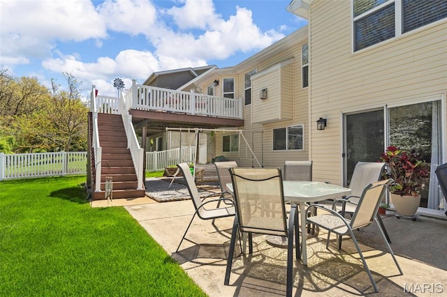 view of patio / terrace with stairs, a wooden deck, and outdoor dining space