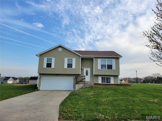 raised ranch featuring a garage, driveway, and a front yard