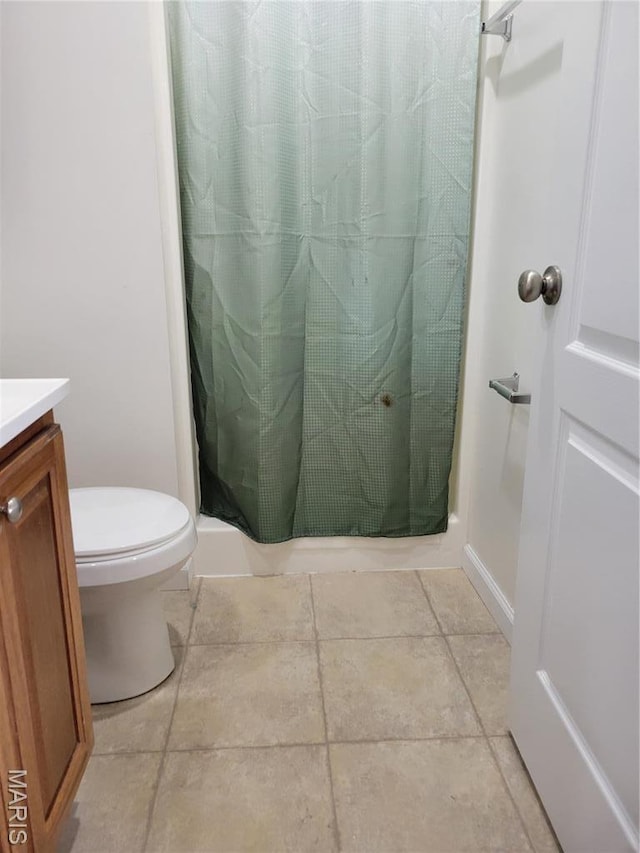 full bathroom featuring vanity, a shower stall, and toilet