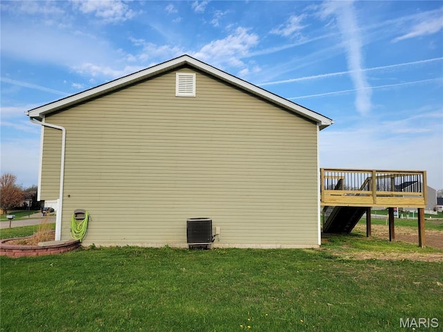 view of property exterior featuring a wooden deck, a yard, and central AC
