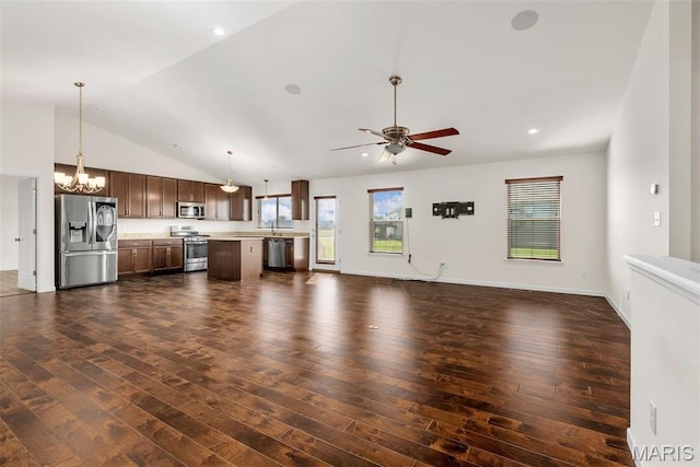 unfurnished living room featuring ceiling fan, dark wood finished floors, a chandelier, vaulted ceiling, and a sink