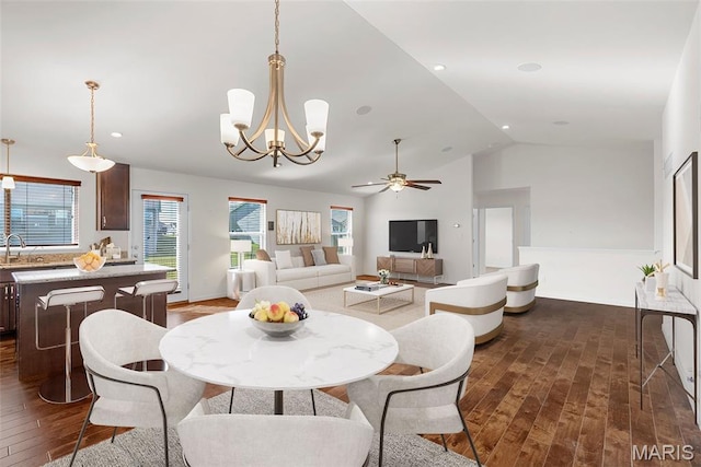 dining space featuring dark wood finished floors, ceiling fan, a chandelier, recessed lighting, and high vaulted ceiling