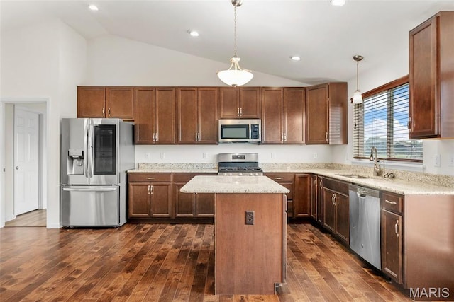 kitchen featuring appliances with stainless steel finishes, a sink, a center island, dark wood finished floors, and pendant lighting